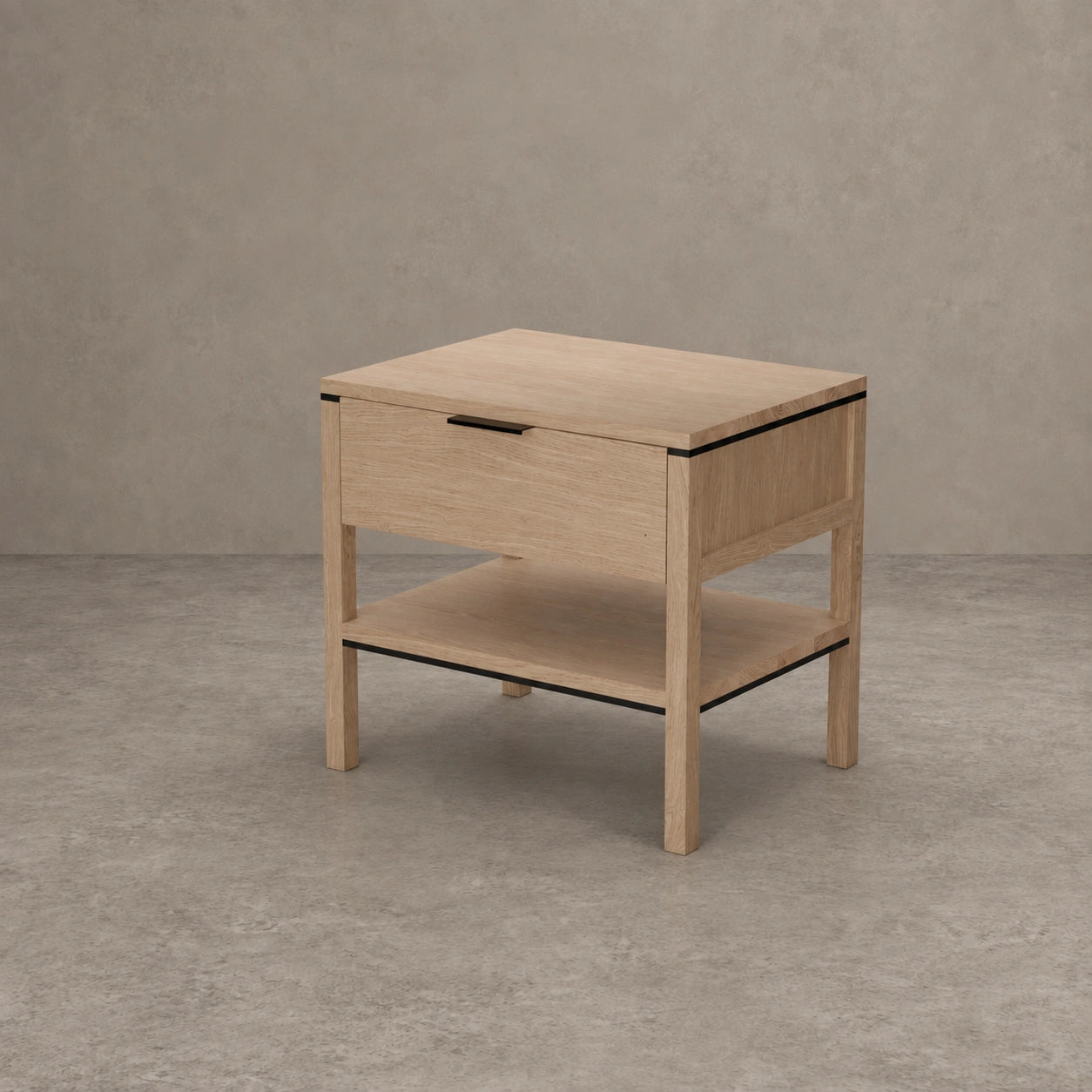 A light oak wood nightstand with a single drawer, open lower shelf, and thin black metal trim accents, set against a textured gray concrete wall and floor.