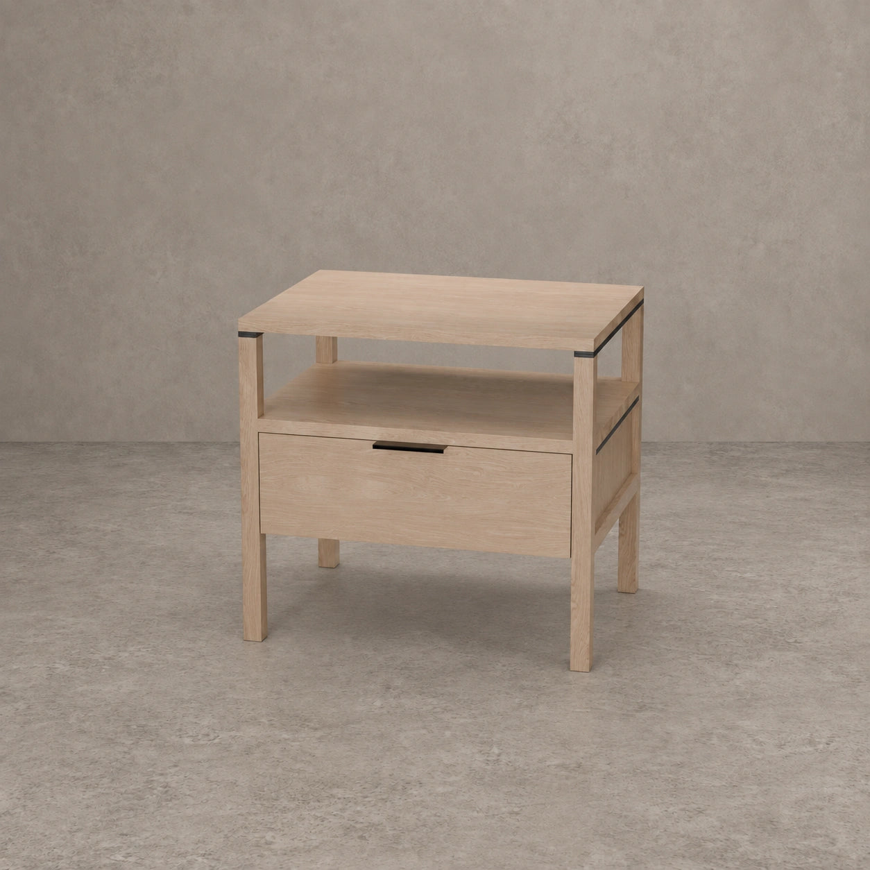 A light natural wood nightstand with a single drawer, open shelf, and open top surface, shown against a textured gray concrete wall and floor.